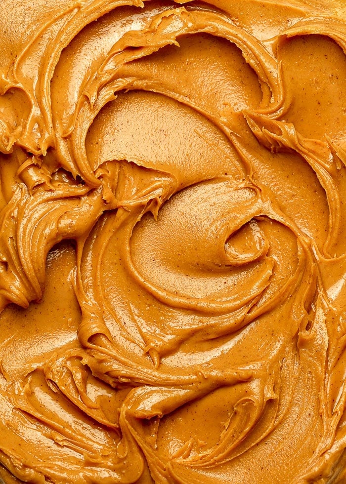 Close up, full frame photo of swirls of creamy peanut butter.