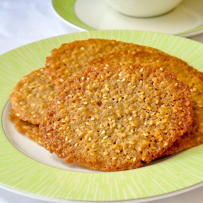 Sesame Wafer Cookies on a white plate with tea on the side