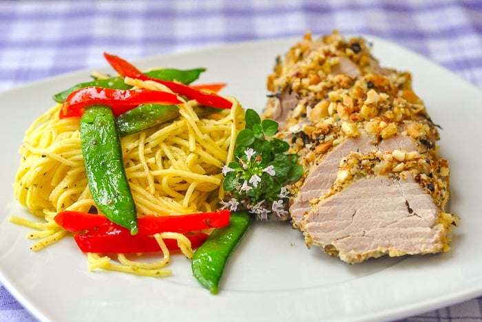 Almond Herb Crusted Pork Tenderloin photo of single serving with pasta primavera on the side