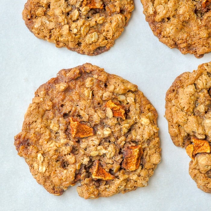 Apple Crumble Cookies close up shot on parchment paper lined cookie sheet.