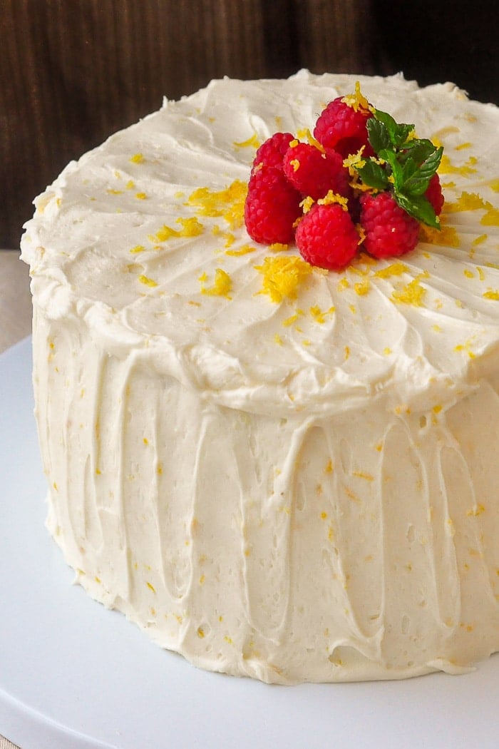 Raspberry Lemon Buttercream Cake Photo of the frosted cake on a white serving plate