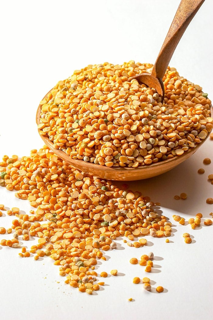 stock photo of dried yellow split peas in a wooden bowl