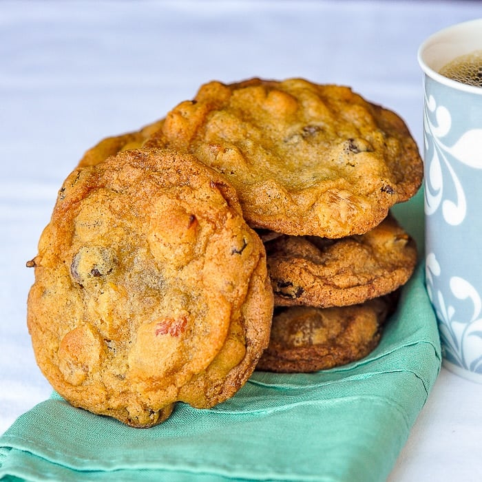 Crispy Chewy Apricot Raisin Cookies shown with coffee cup and napkin