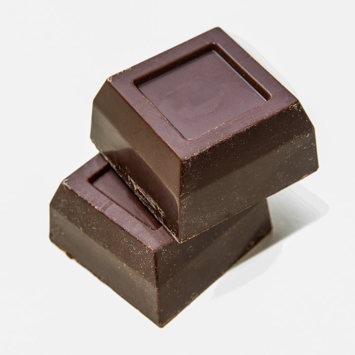1 ounce blocks of unsweetened dark chocolate on a white background