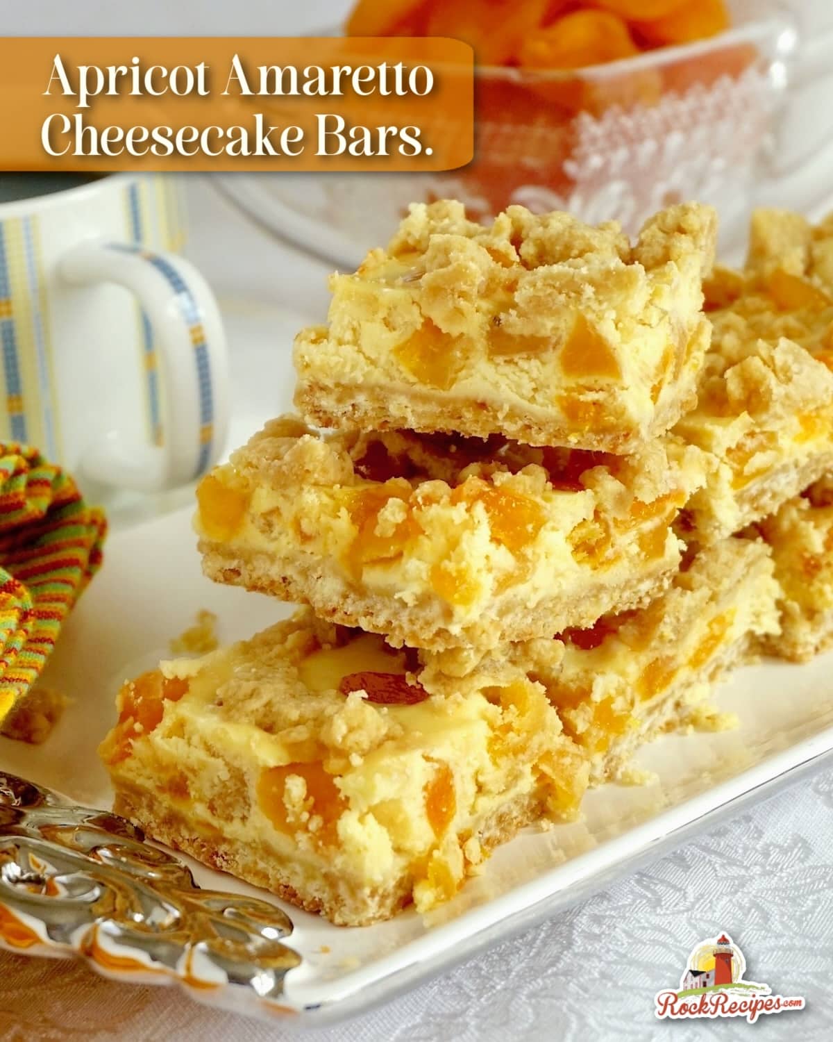 Photo of Apricot Amaretto Cheesecake Bars photo of stacked cookie bars with title text added for Pinterest and social media posts.