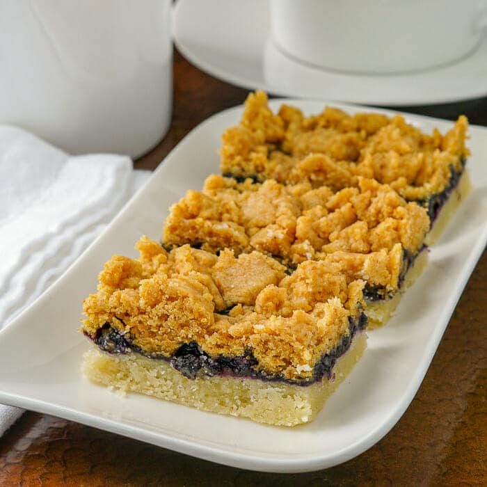 Blueberry Crumble Bars shown on a white plate.