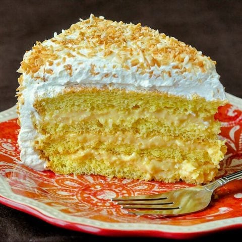 Coconut Cream Cake showing a cut slice.