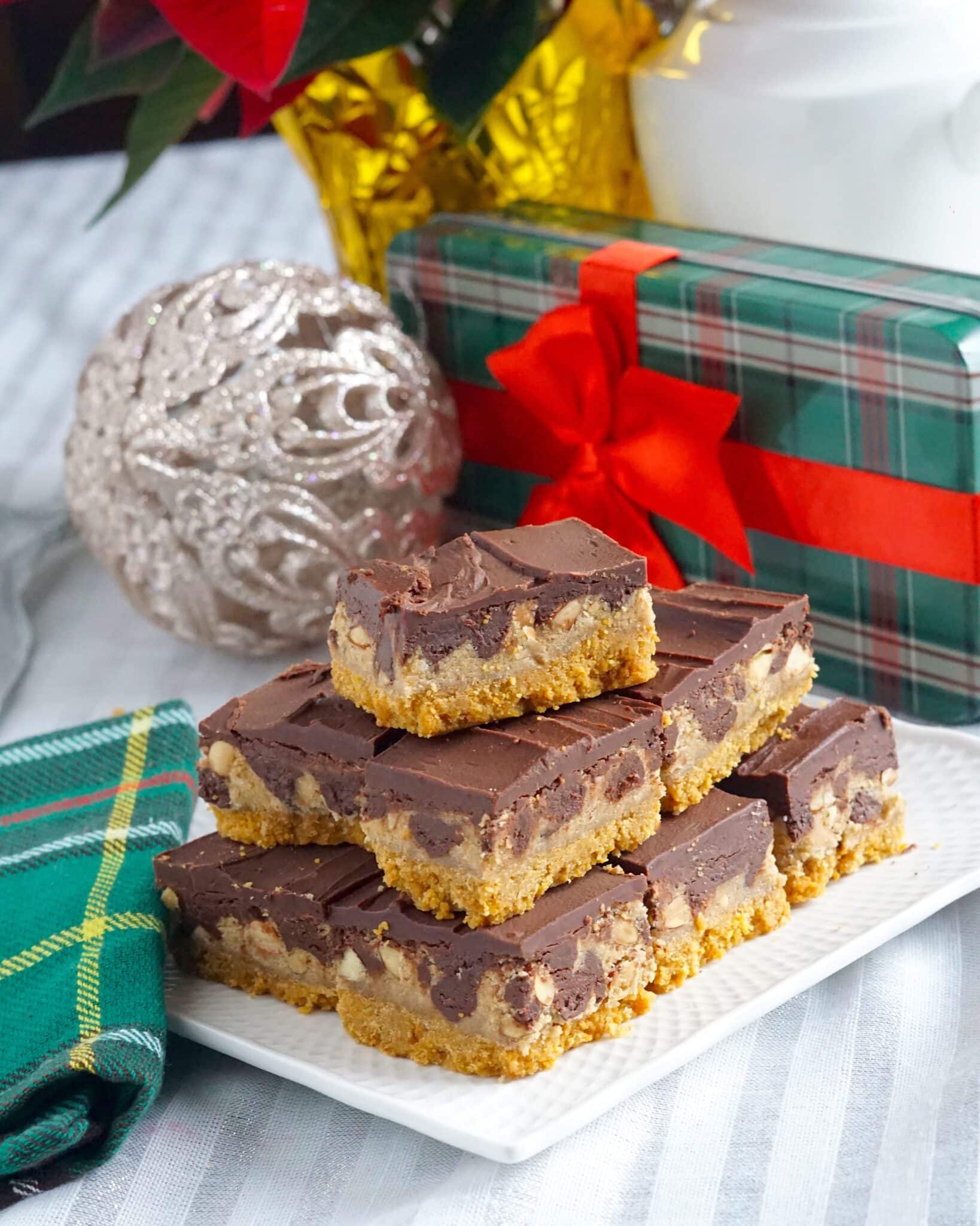 Almond Roca Cookie Bars. Stacked on a white plate with christmas decoration background.