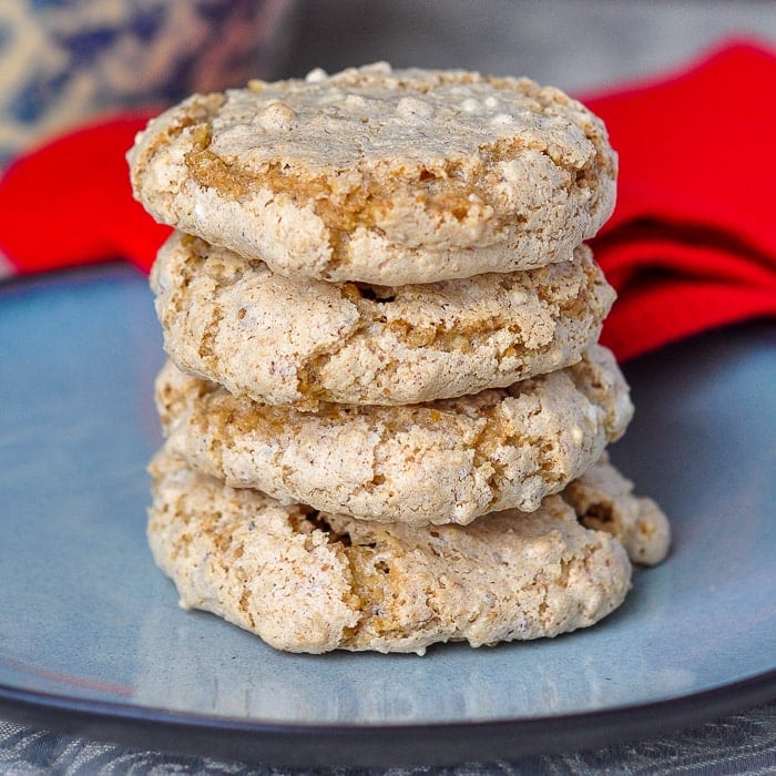 Nut Meringue Cookies stacked on a blue plate with red napkin in background