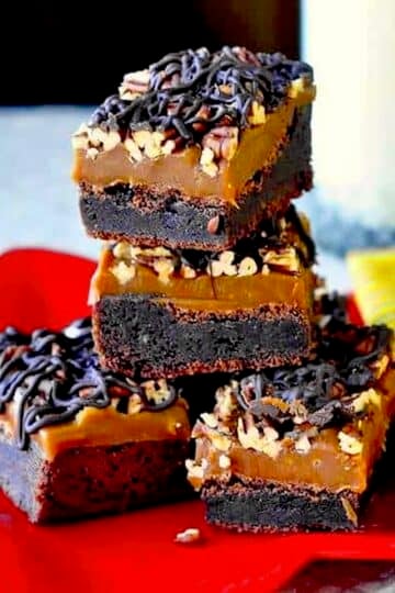 Turtle Brownies stacked in a red star shaped plate.