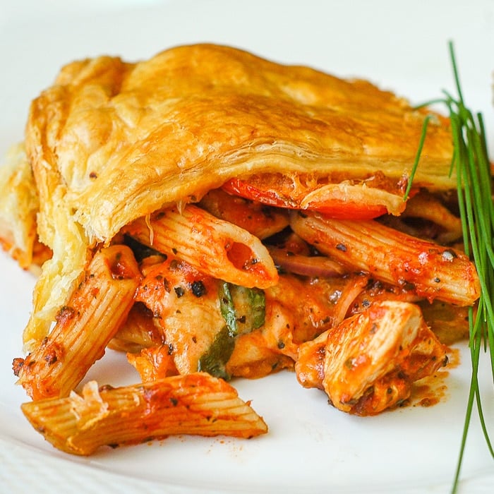 Chicken Penne Timpano close up photo of a single serving on a white plate