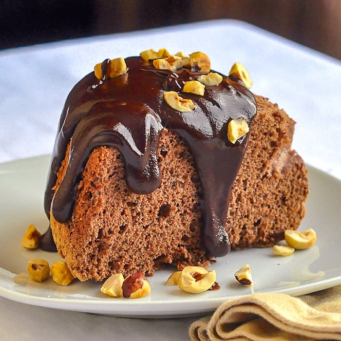 Chocolate Angel Food Cake with Nutella Ganache Sauce close up image of singe slice on a white plate