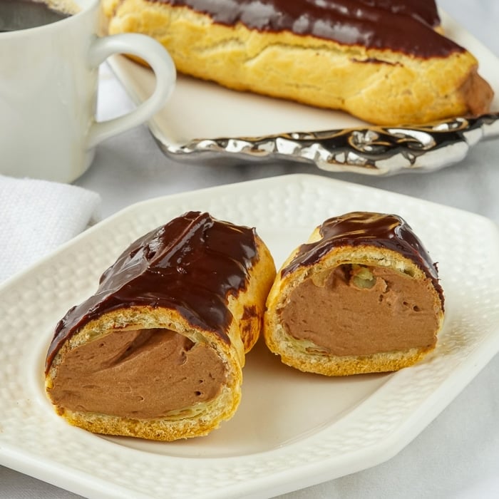 Chocolate-Mousse-Eclairs-photo-of-one-eclair-cut-open-to-reveal-filling.jpg