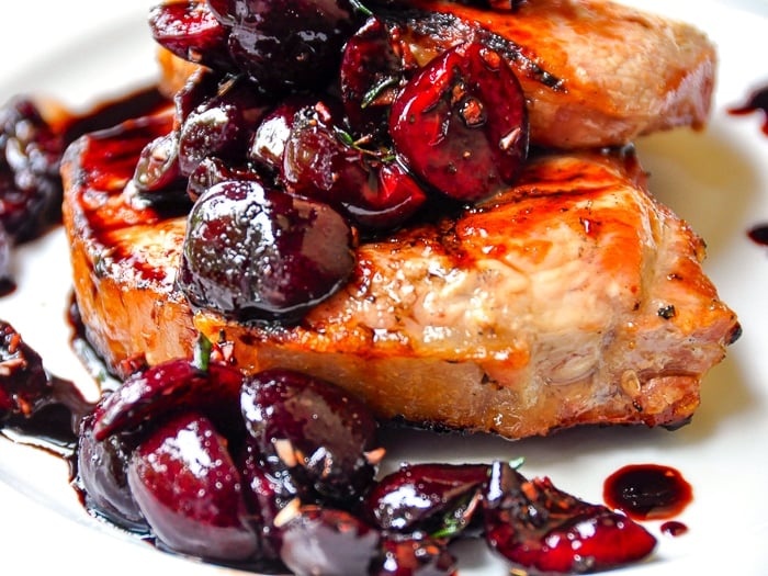 Close up photo of Grilled Pork Chops with Balsamic Thyme Cherries