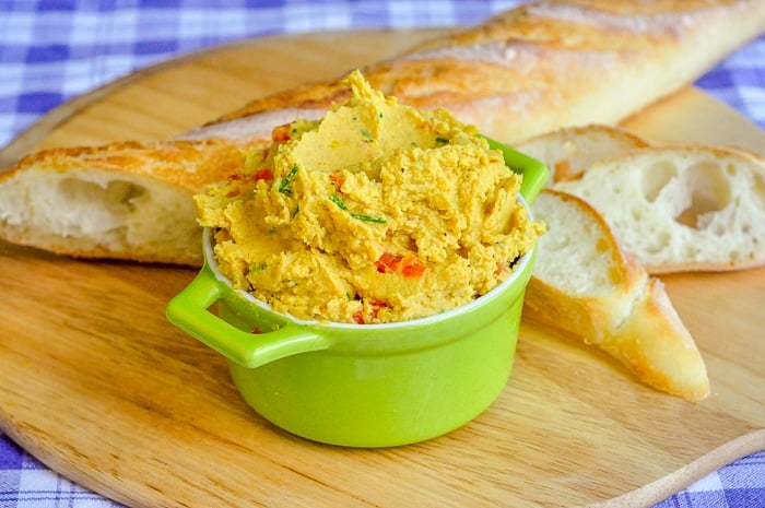 Curry Spiced Roasted Red Pepper Hummus shown with baguette