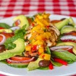Lime Cumin Grilled Chicken Salad with Avocado and Mango Salsa photo of a single serving on a white plate