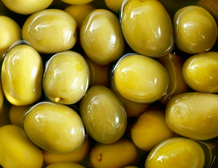 Olives shown close up in brine.