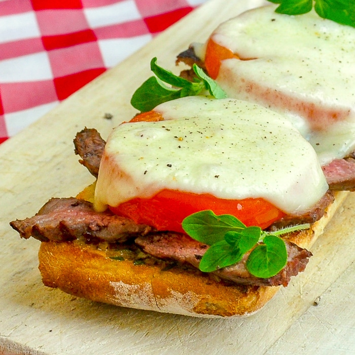 Open Face Tomato Provolone Steak Sandwich close up square cropped feature image