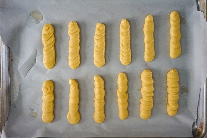 Pipe dough onto a parchment lined baking sheet