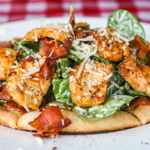 Spinach Caesar Salad with Chicken on a white plate