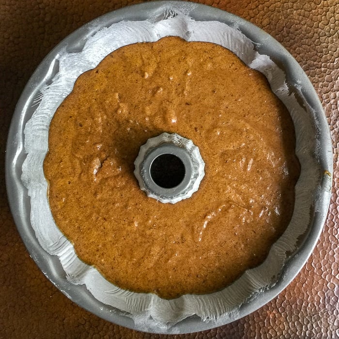 Sticky toffee pudding in a bundt pan ready for the oven