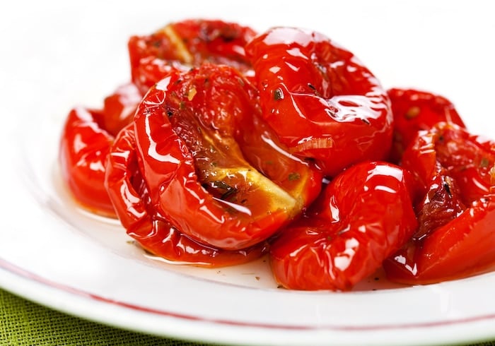 Sun dried tomatoes on white plate 