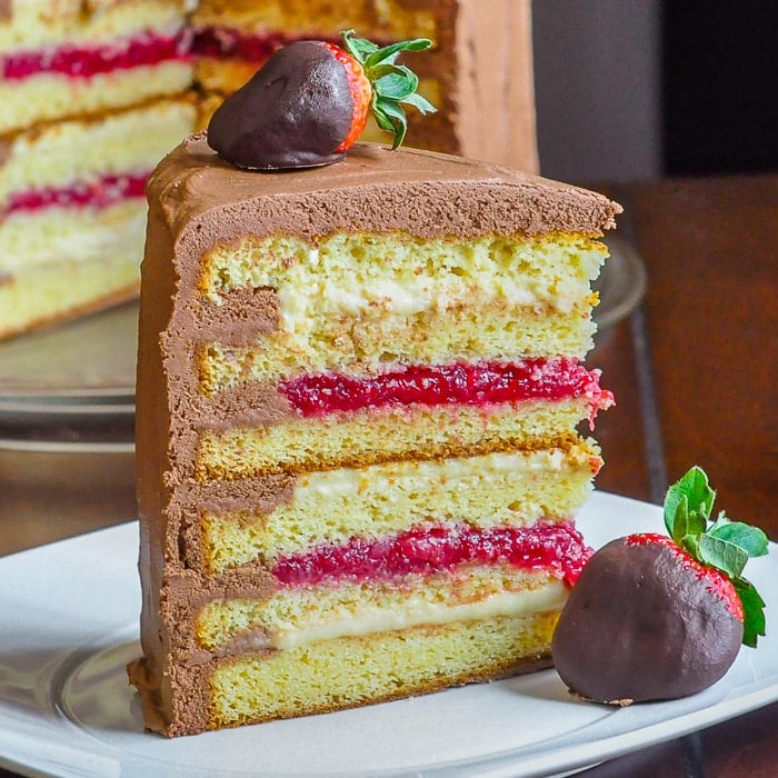 Too Tall Neapolitan Cake close up of a single slice of cake on a white plate