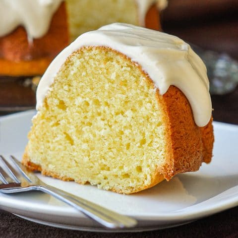 Vanilla Cream Cheese Bundt Cake close up photo of a single slice on a white plate