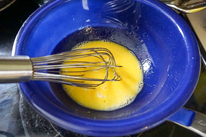 Whisk together the egg yolks sugar and water