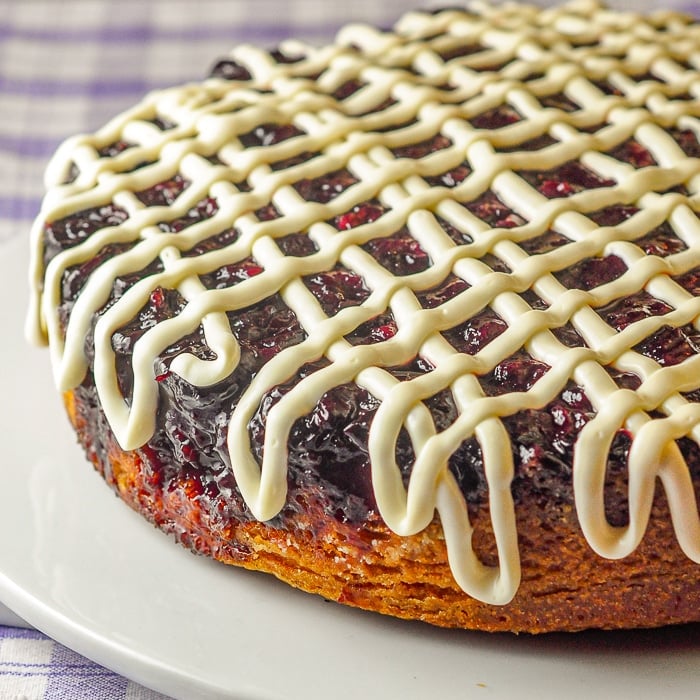 Cherry Vanilla Coffee Cake close up photo of finished uncut cake on a white cake plate