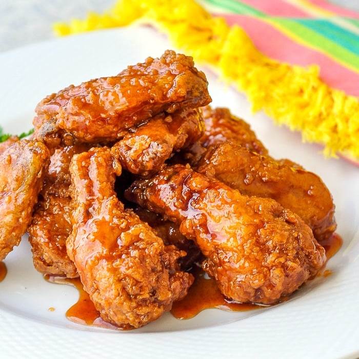 Crunchy Sticky Honey Barbecue Wings close up photo of wings on a white platter