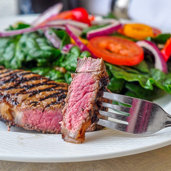 Dijon Balsamic Marinated Steak close up of cut steak showing perfect medium rare centre