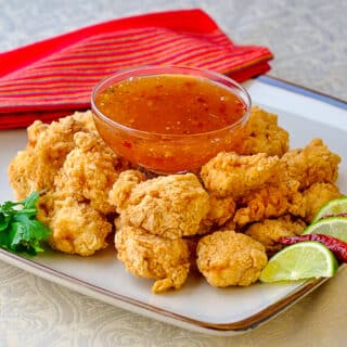 Double Crunch Popcorn Shrimp with Chili Lime Dipping Sauce shown on serving platter with dip in the centre