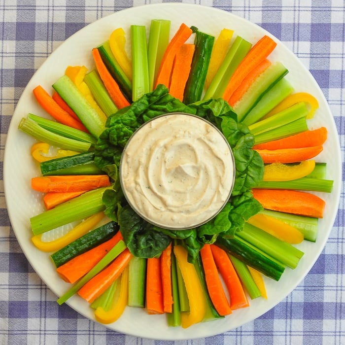 Low Fat Chipotle Ranch Dip with vegetables on a white serving platter.