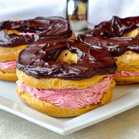 Raspberry Chocolate Paris Brest close up photo of the pastries on a white plate