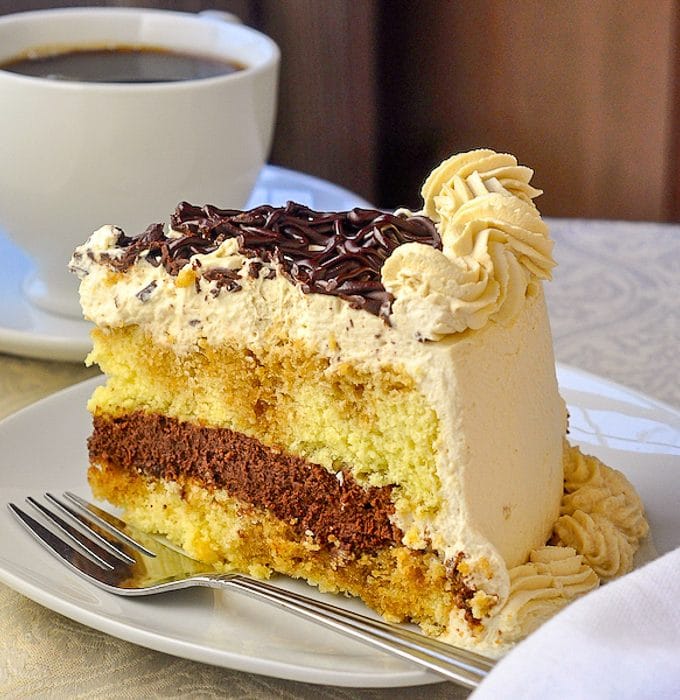 Chocolate Filled Kahlua Tiramisu Cake close up photo of a single slice on a white plate
