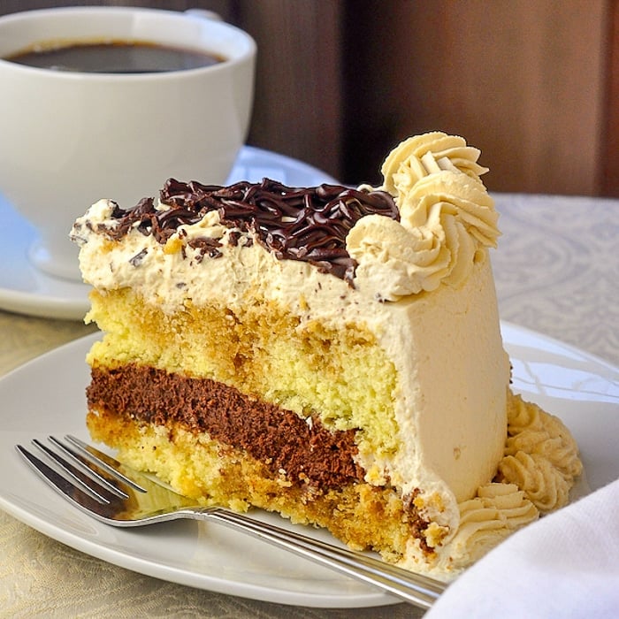 Chocolate Filled Kahlua Tiramisu Cake close up photo of a single slice on a white plate