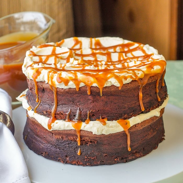 Gluten Free Chocolate Cake with Irish Cream Whipped Cream featured image on white serving plate