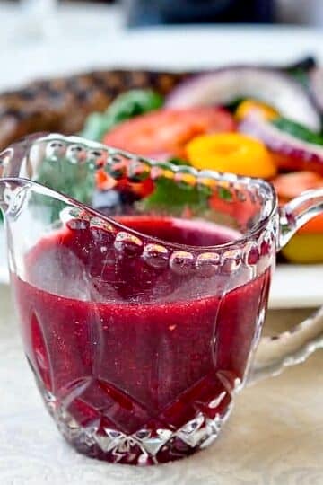 Raspberry Balsamic Vinaigrette photo of dressing in a clear glass crystal jug.