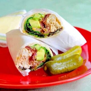 Smokey Spiced Homemade Mayonnaise in Avocado Turkey Club Wraps square cropped featured image of a wrap on a white plate