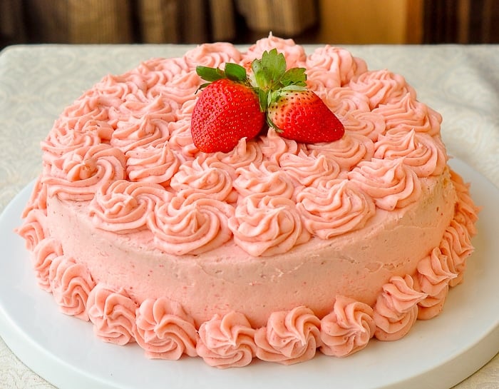 Strawberry Mascarpone Cream Cake wide shot phot of whole finished cake on a white serving plate