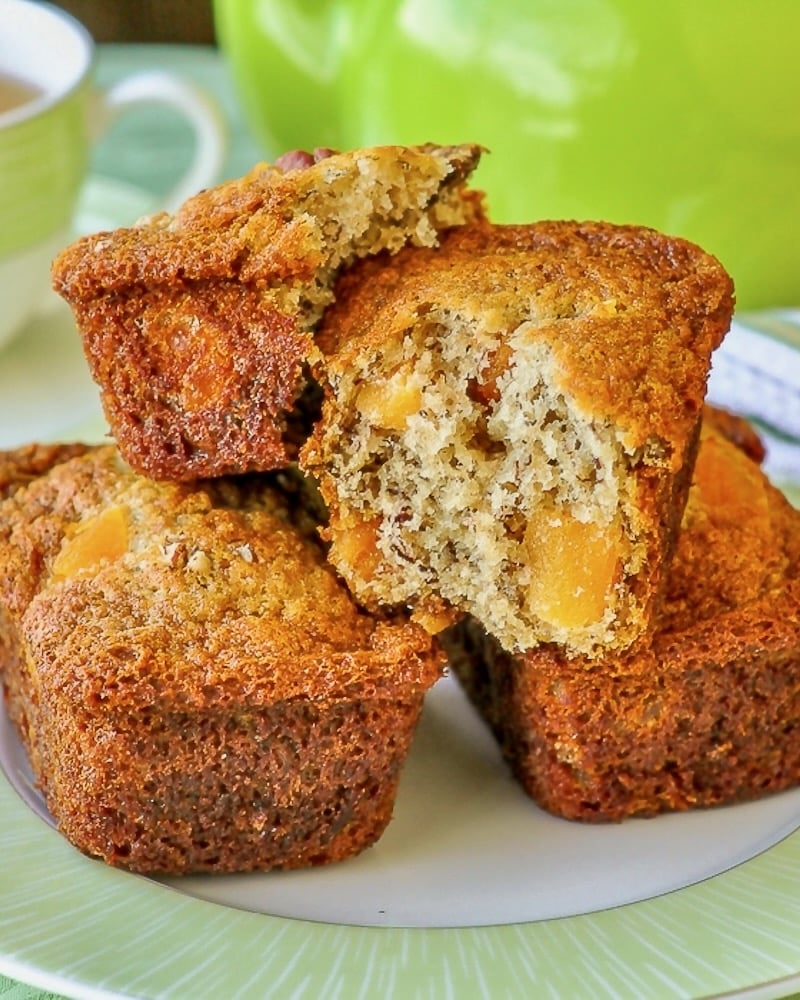 Apricot Pecan Banana Crinkle Cakes shown broken open to show inside with a green tea service in backgrpund.