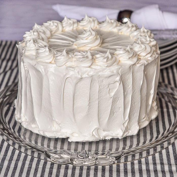 Black and White Cake Photo of entire frosted cake on a glass cake plate