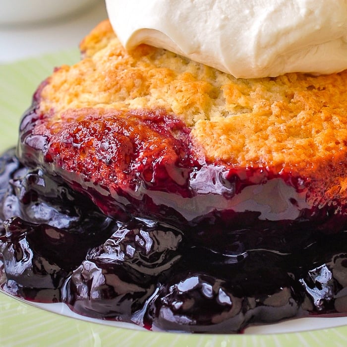 Close up photo of the cherry sauce underneath the cherry cobbler