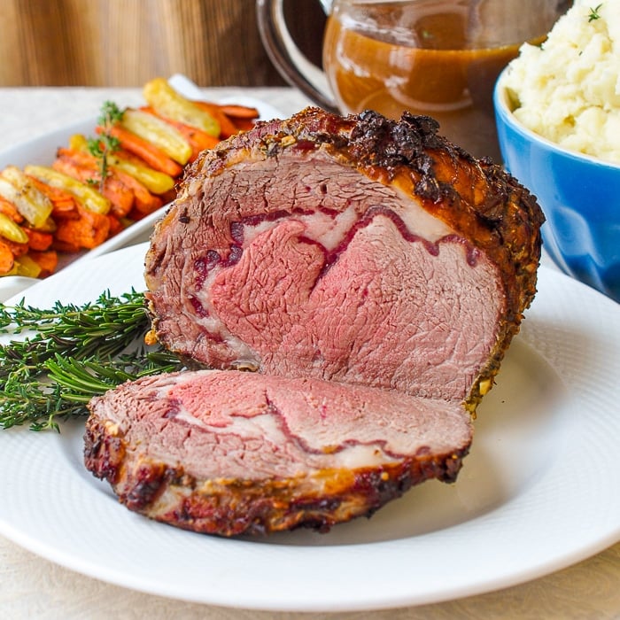 Herb and Garlic Crusted Prime Rib Roast cut to show a centre which is medium rare