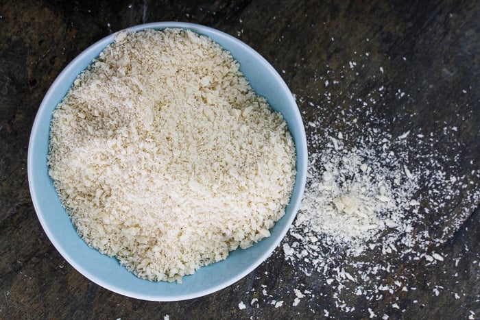 Stock Photo of panko bread crumbs on a black background and in a blue bow. 