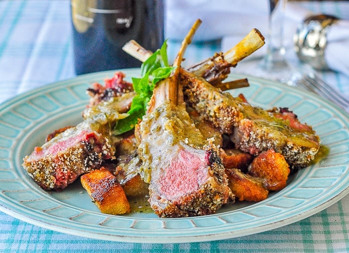 Parmesan Panko Crusted Rack of Lamb wide shot of a serving presented on a teal coloured dinner plate