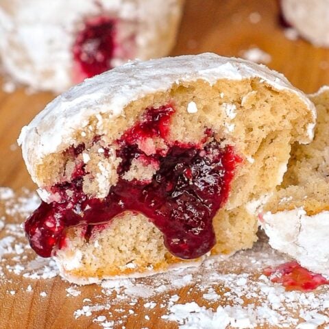 Raspberry Filled Donut Muffins close up photo of one muffin split in half to reveal filling