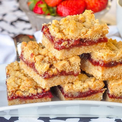 Strawberry Crumble close up photo of stacked cookie bars on a white plate