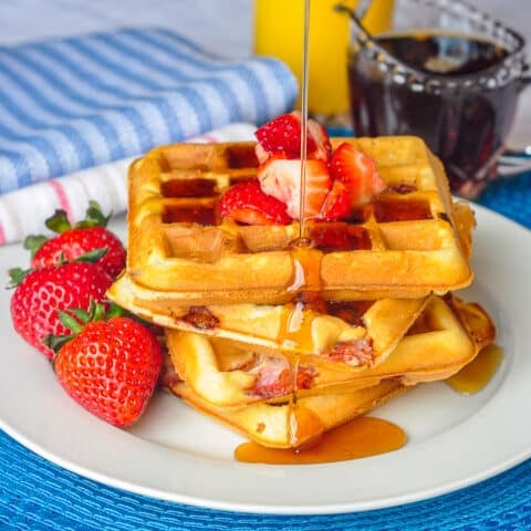 Strawberry Muffles close up photo of waffles with fresh strawberries and maple syrup